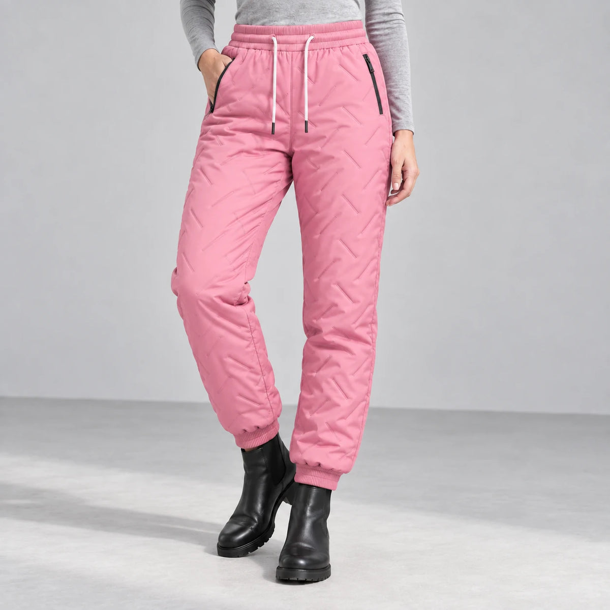 Women’s fleece-lined winter pants in pink — front studio view