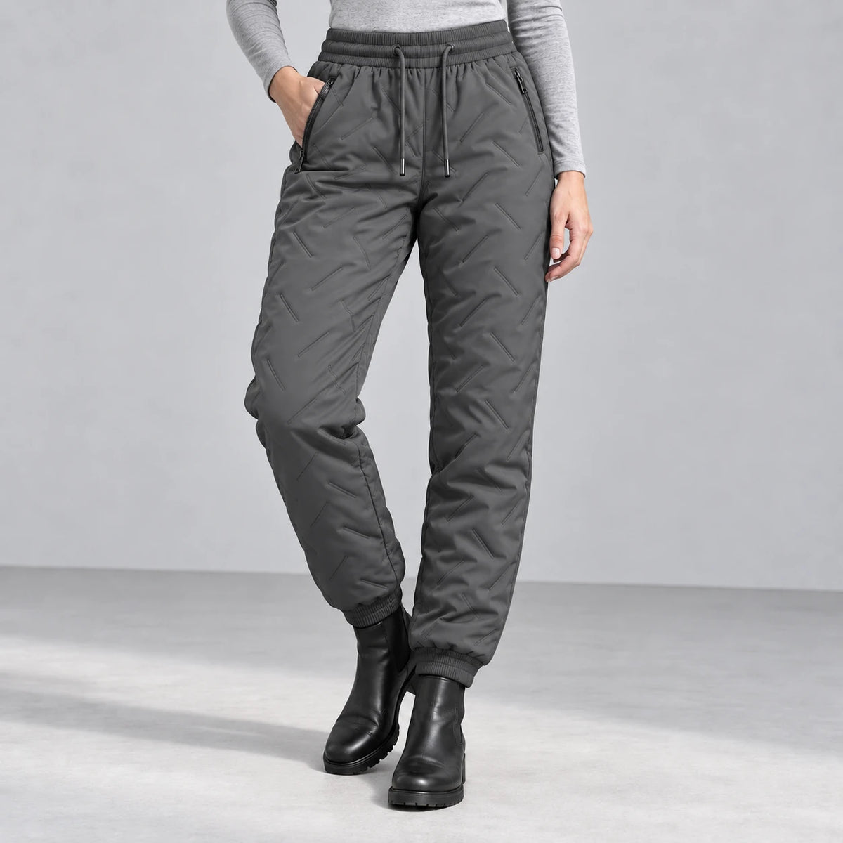 Women’s fleece-lined winter pants in charcoal gray — front studio view