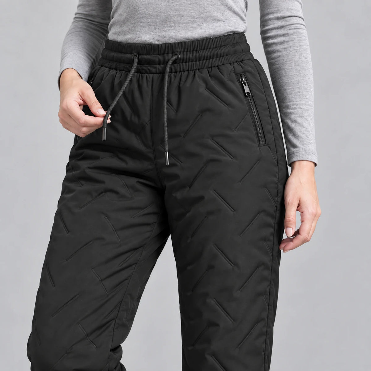 Black winter pants — waistband and zip pocket detail