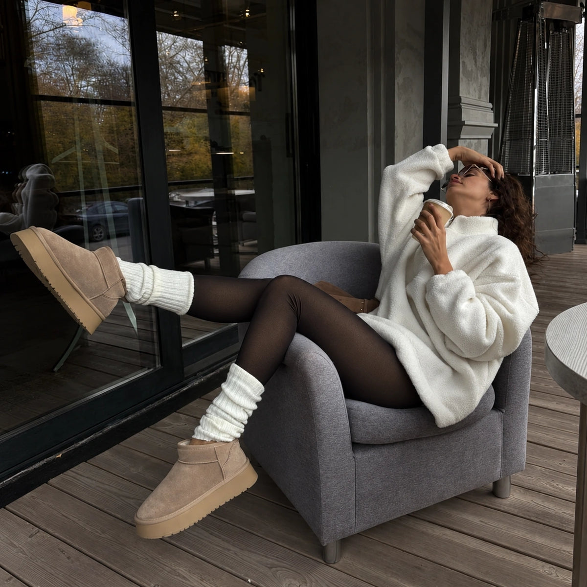 Luma black fleece-lined tights styled on a winter terrace