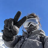 Woman wearing black winter gloves in alpine snow