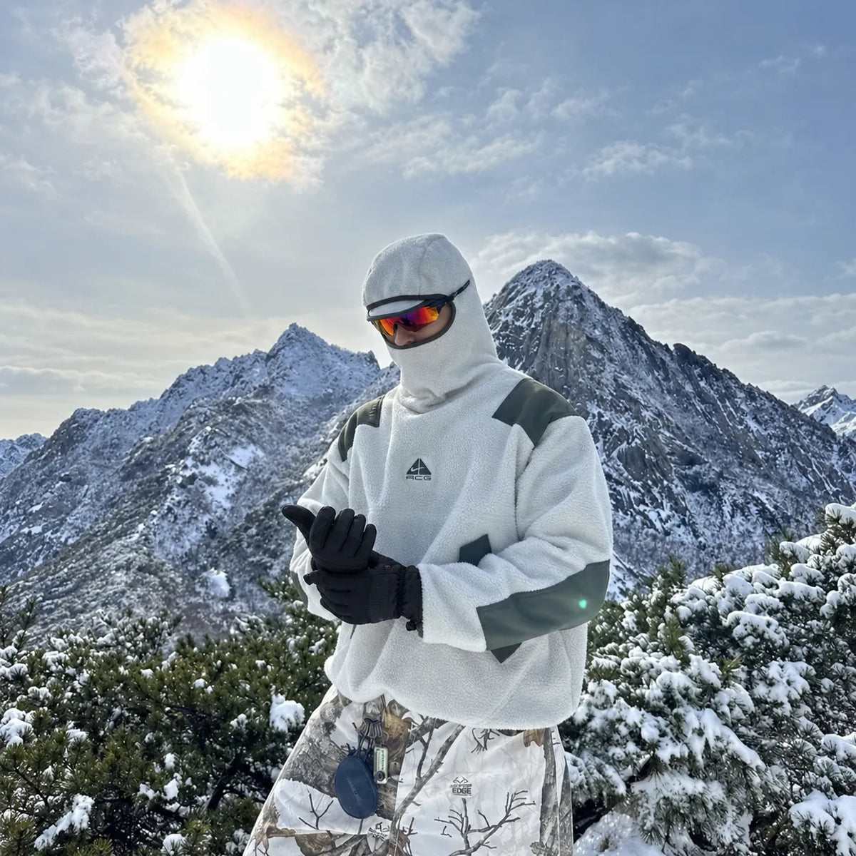 Man adjusting gloves in the snowy mountains