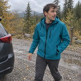 Man wearing the Petrol Ridge Shell at an autumn trailhead
